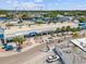 Charming street view with a modern building, palm trees and parked cars, showing its accessibility and convenience at 1532 Citrine Trl, Tarpon Springs, FL 34689