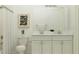 Well-lit bathroom featuring a double sink vanity with elegant fixtures and stylish decor at 16941 Falling Waters Ct, Land O Lakes, FL 34638