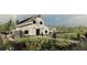 Charming exterior view of a barn-style building with a vibrant garden in the foreground at 16941 Falling Waters Ct, Land O Lakes, FL 34638