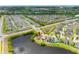 Panoramic aerial shot of a lakefront property, displaying lush landscaping and a desirable residential community at 1811 Redmond Brook Ln, Ruskin, FL 33570