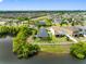 Picturesque aerial view of a lakeside property with a lush green lawn, located in a vibrant residential area at 1811 Redmond Brook Ln, Ruskin, FL 33570