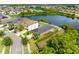 Breathtaking aerial view of a lakefront property, featuring lush landscaping and a charming residential neighborhood at 1811 Redmond Brook Ln, Ruskin, FL 33570
