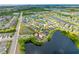 Aerial view of lakeside home with lush greenery around a beautiful community with multiple ponds and common areas at 1811 Redmond Brook Ln, Ruskin, FL 33570