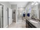 Elegant bathroom with a granite countertop vanity, a tiled walk-in shower, and a separate toilet room at 1811 Redmond Brook Ln, Ruskin, FL 33570