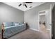 Neutral guest bedroom with a daybed, fan, and doorway leading to another room at 1811 Redmond Brook Ln, Ruskin, FL 33570