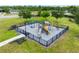 Aerial view of a fenced playground with slides, swings, climbing structures, and picnic tables at 1811 Redmond Brook Ln, Ruskin, FL 33570