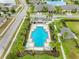 Aerial shot of community pool surrounded by palm trees, lounge chairs, and well-maintained landscaping at 1811 Redmond Brook Ln, Ruskin, FL 33570