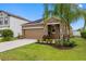 Well-maintained single-story home with a two-car garage, stone accents, and landscaped yard at 1811 Redmond Brook Ln, Ruskin, FL 33570