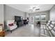 Cozy living area with tile flooring, modern furnishings, and natural light from the windows and glass door at 1811 Redmond Brook Ln, Ruskin, FL 33570