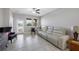 Inviting living room with tile floors, a three-seat sofa, and large windows providing ample natural light at 1811 Redmond Brook Ln, Ruskin, FL 33570