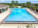 Community pool features a zero entry, chairs, lounging options and clear, blue water at 1811 Redmond Brook Ln, Ruskin, FL 33570