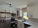 Modern kitchen with stainless steel appliances, white cabinets, and quartz countertops at 1907 E 111Th Ave, Tampa, FL 33612