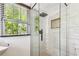 Modern bathroom with a glass walk-in shower with stylish tile and black hardware at 233 24Th N St, St Petersburg, FL 33713