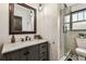 Bathroom vanity with marble countertop, modern fixtures, and glass-enclosed shower with stylish tile work at 233 24Th N St, St Petersburg, FL 33713