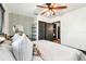 Spacious bedroom with king bed, modern light fixture, neutral colors, and decorative wallpaper accent wall at 233 24Th N St, St Petersburg, FL 33713