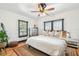 Cozy bedroom with a large window, hardwood floors, ceiling fan, and neutral decor at 233 24Th N St, St Petersburg, FL 33713