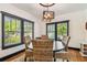 Bright dining room with wicker chairs, hardwood floors, and ample natural light from the surrounding windows at 233 24Th N St, St Petersburg, FL 33713