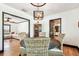 Inviting dining room showcasing hardwood floors, a round table with wicker chairs, and an open view to the living room at 233 24Th N St, St Petersburg, FL 33713