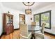Cozy dining room featuring a round table, wicker chairs, hardwood floors, and a unique chandelier at 233 24Th N St, St Petersburg, FL 33713