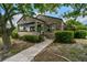 Charming stone home with a welcoming covered front porch and well-maintained landscaping at 233 24Th N St, St Petersburg, FL 33713
