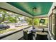 Inviting covered front porch with comfortable seating, perfect for relaxing and enjoying the neighborhood views at 233 24Th N St, St Petersburg, FL 33713
