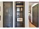 Hallway with stylish black bookshelf and view into kitchen at 233 24Th N St, St Petersburg, FL 33713