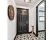 Entry way featuring decorative tile, a dark-colored door, and a glimpse into a brightly lit adjoining room at 233 24Th N St, St Petersburg, FL 33713