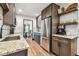 Well-lit kitchen with stainless steel appliances, granite countertops, wood floors, and open access to dining area at 233 24Th N St, St Petersburg, FL 33713