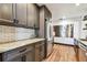 Bright kitchen with stainless steel refrigerator, granite countertops, shaker cabinets, and subway tile backsplash at 233 24Th N St, St Petersburg, FL 33713