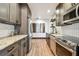 Modern kitchen featuring stainless steel appliances, granite countertops, subway tile backsplash, and hardwood floors at 233 24Th N St, St Petersburg, FL 33713