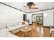 Open-concept living room with hardwood floors, a sectional sofa, and an inviting view into the dining area at 233 24Th N St, St Petersburg, FL 33713