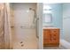 This bathroom features a shower with safety bars next to the oak vanity at 2509 Lambdin Dr, Sun City Center, FL 33573