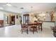 Dining area with wood table and chairs, flowing into the kitchen and offering access to outdoor space at 2509 Lambdin Dr, Sun City Center, FL 33573