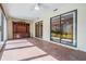 Enclosed lanai with tile flooring, ceiling fan, and sliding glass doors provides access to the outdoors at 2509 Lambdin Dr, Sun City Center, FL 33573