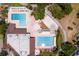 Overhead view of a community pool area complete with multiple pools, seating, and recreational facilities at 2665 Clubhouse N Dr, Clearwater, FL 33761