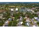 An aerial view featuring a residential area near a community center with tennis courts and a golf course at 2665 Clubhouse N Dr, Clearwater, FL 33761