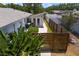 Aerial view of a fenced backyard with lush landscaping and a shed at 2665 Clubhouse N Dr, Clearwater, FL 33761
