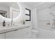 Stylish bathroom with modern fixtures, a round mirror, and a shower-tub combo at 2665 Clubhouse N Dr, Clearwater, FL 33761