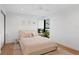 Bright bedroom with a pink-themed bed, neutral rug and decor, and natural light at 2665 Clubhouse N Dr, Clearwater, FL 33761