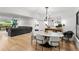 Open dining area features modern lighting, decor, with view to the living room and backyard at 2665 Clubhouse N Dr, Clearwater, FL 33761