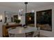 Modern dining room featuring stylish lighting, a sleek table, and views of the lush outdoor space at 2665 Clubhouse N Dr, Clearwater, FL 33761