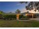 Charming single-story home featuring a well-manicured lawn, a covered entryway, and an attached garage at 2665 Clubhouse N Dr, Clearwater, FL 33761