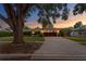Inviting exterior view of a home with a well-kept front yard and a charming facade at sunset at 2665 Clubhouse N Dr, Clearwater, FL 33761