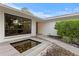 Modern home exterior with unique water feature and minimalist landscaping at 2665 Clubhouse N Dr, Clearwater, FL 33761