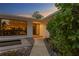 Contemporary front entrance with a stepping stone path, lush landscaping, and a modern glass door at 2665 Clubhouse N Dr, Clearwater, FL 33761