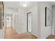 Bright hallway with wood floors leading to a bathroom and other rooms at 2665 Clubhouse N Dr, Clearwater, FL 33761