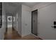 Bright hallway featuring wood floors and access to the sleek, modern bathroom with a circular mirror at 2665 Clubhouse N Dr, Clearwater, FL 33761