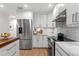 Modern kitchen with stainless steel appliances, granite countertops, and white subway tile backsplash at 2665 Clubhouse N Dr, Clearwater, FL 33761