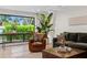 Bright living room with hardwood floors, modern furnishings, and view of the landscaped yard at 2665 Clubhouse N Dr, Clearwater, FL 33761