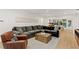 Spacious living room with modern decor, a comfortable gray sofa, and an adjacent dining area at 2665 Clubhouse N Dr, Clearwater, FL 33761